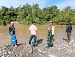 Curah Hujan Tinggi Babinsa Koramil 01/Sungaimas Pantau Air Sungai di Desa Binaan